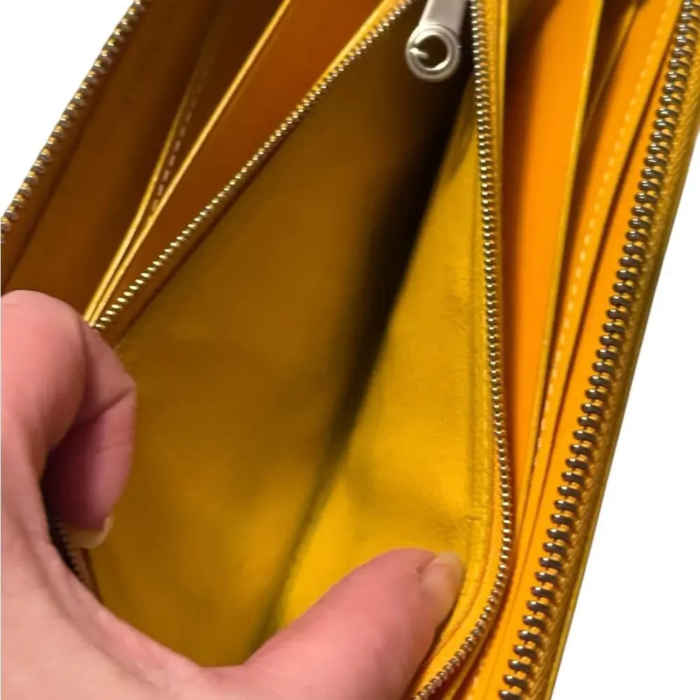 Goyard Matignon zip-around wallet in yellow orange Goyardine canvas.